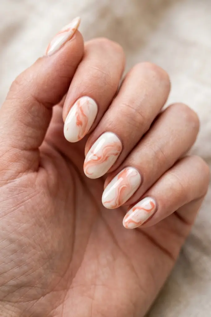 coral-swirl-marble-soft-white-oval-nails