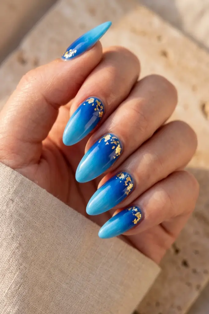 blue-ombre-gold-flakes-almond-summer-nails