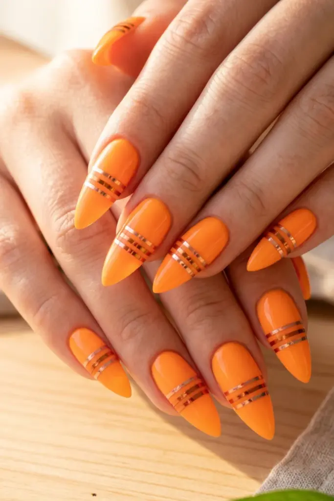 tangerine-neon-thin-metallic-stripes-stiletto-acrylic-summer-nail-design-ideas