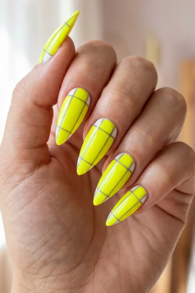 yellow-neon-abstract-grid-stiletto-acrylic-summer-nail-design-ideas