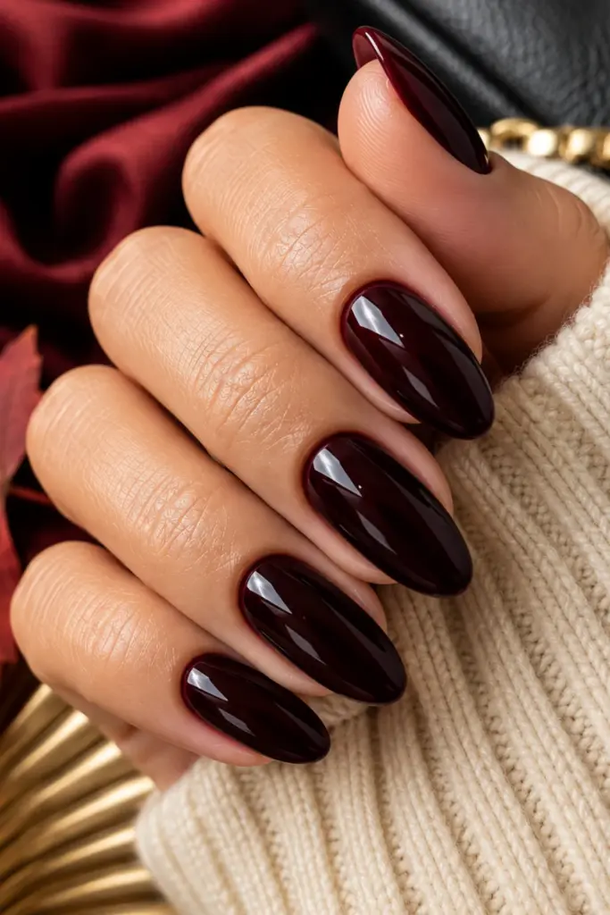 Classic black cherry manicure with glossy deep red-black nails for a sophisticated, classy fall look.