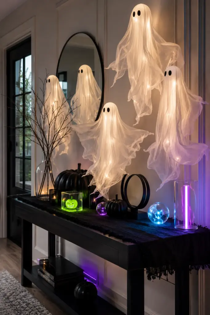 Easy Halloween Entryway Table Decor Designs Ideas for 2026 featuring floating white ghosts, colorful neon accents, modern décor, and glowing Halloween lighting.
