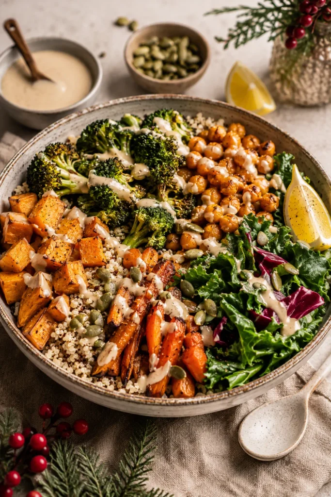 Colorful roasted vegetable and quinoa power bowl with broccoli, sweet potato, chickpeas, and tahini dressing for a healthy winter vegetarian dinner.