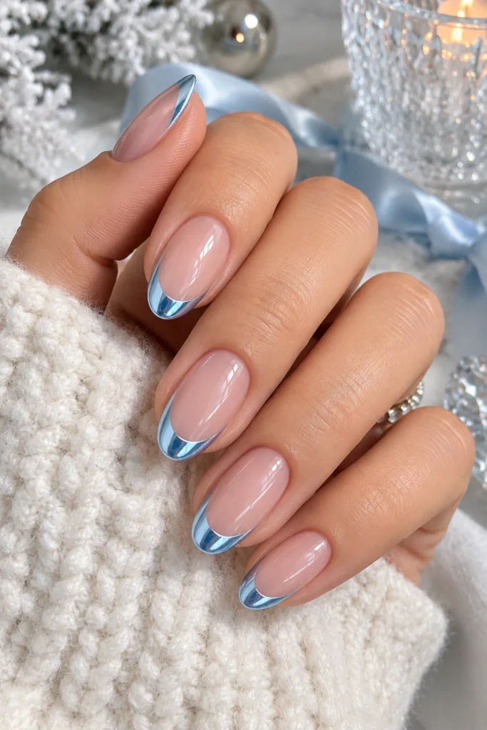 Icy blue chrome French tip winter nails over a sheer nude base with a frosted modern finish for 2026.