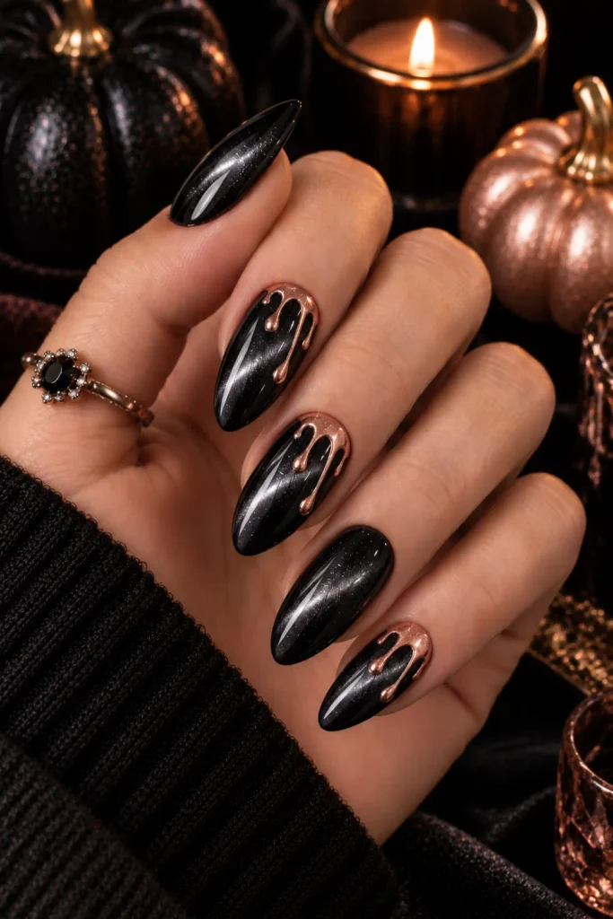Glossy black cat-eye Halloween nails with luminous magnetic shimmer and elegant rose gold drip accents in a chic 2026 design.