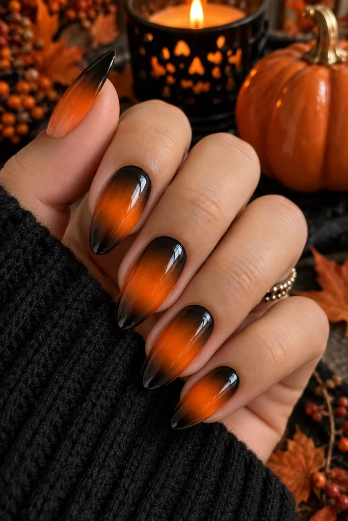 Simple Halloween Almond Nails Design Ideas: Easy looks featuring smooth black and vibrant pumpkin-orange ombre almond nails with a glossy modern Halloween finish.