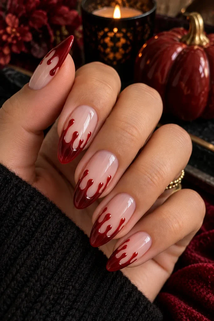 Simple Halloween Almond Nails Design Ideas: Easy looks featuring dramatic glossy red blood-drip accents on almond nails with a modern nude base and elegant Halloween styling.