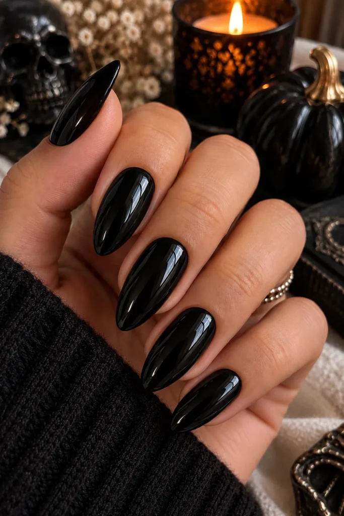 Simple Halloween Almond Nails Design Ideas: Easy looks featuring glossy classic black almond nails with a sleek, sophisticated, minimalist Halloween finish.